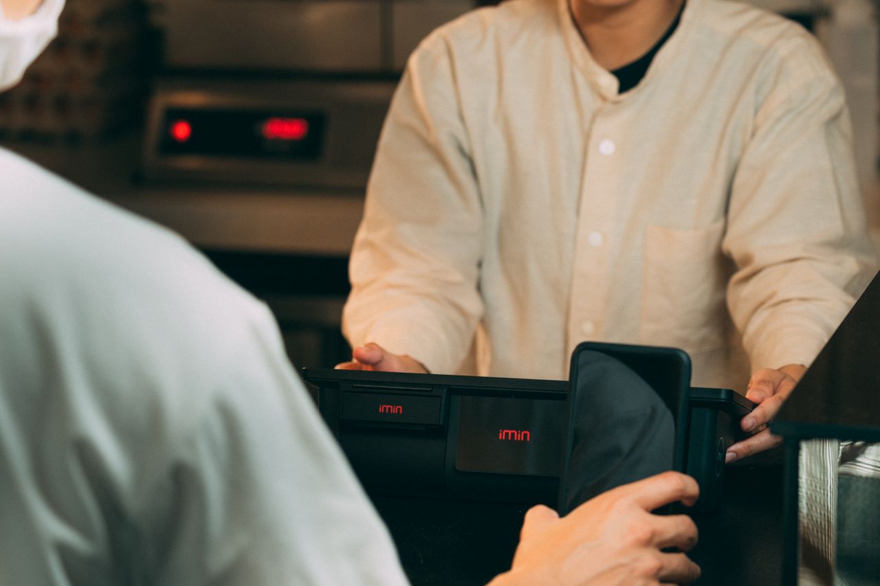 Services Digital payment using smartphone at a modern POS terminal indoors.